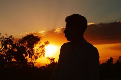 Silhouette man against sky during sunset