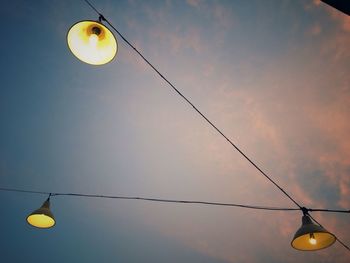 Low angle view of light bulbs against sky