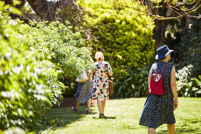 Rear view of women walking in park