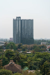 Modern buildings in city against clear sky