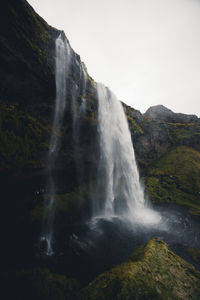 Stunning waterfall in iceland during dark moody weather