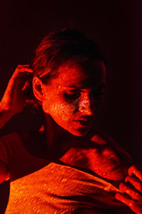 Close-up portrait of mid adult man in darkroom