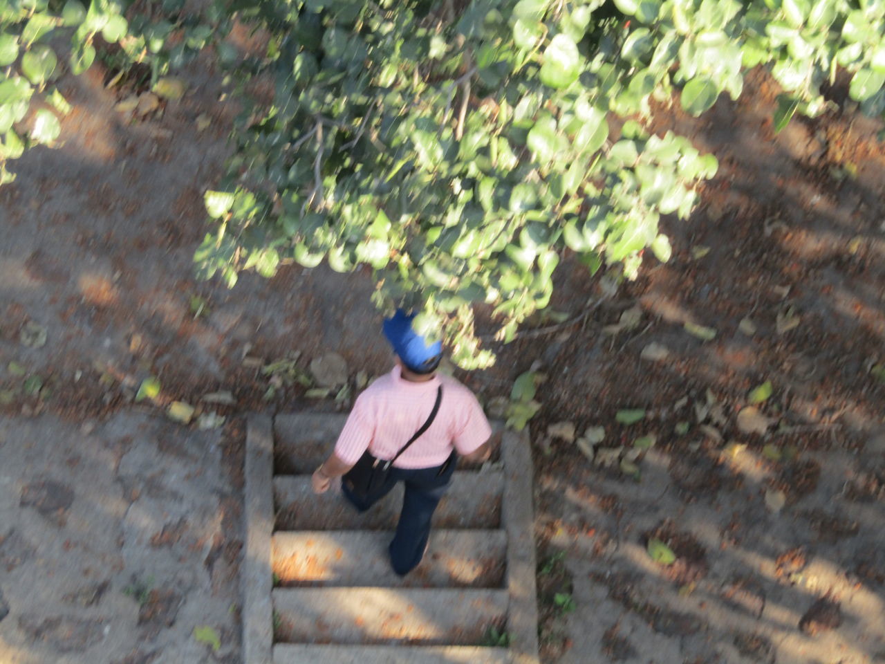 REAR VIEW OF MAN STANDING ON FOOTPATH DURING RAINY SEASON