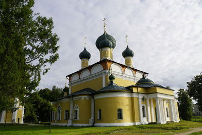 Low angle view of church against cloudy sky