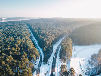 High angle view of road amidst trees against sky