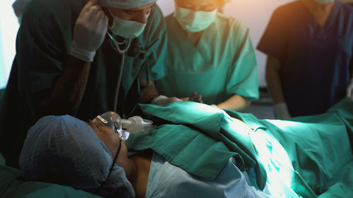 A surgeon performing a surgical procedure. concept hospital care