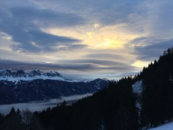 Scenic view of mountains against cloudy sky