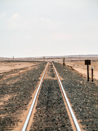 Surface level of railroad tracks against clear sky