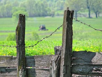 Close-up of wooden fence on field