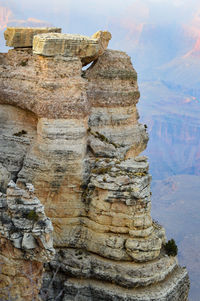Low angle view of rock formation against sky
