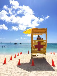 Rear view of man in lifeguard hut at beach