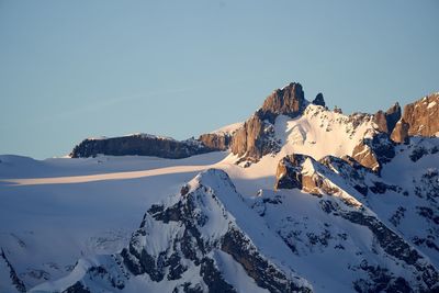 Scenic view of snow covered mountains against sky