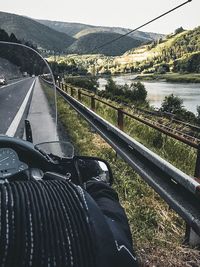 Scenic view of river by mountains against sky