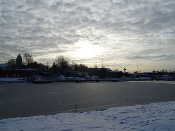 Frozen lake against sky during winter