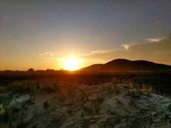 Scenic view of field against sky during sunset