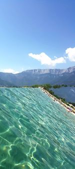 Scenic view of swimming pool by sea against sky