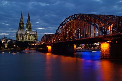 Bridge over river against cloudy sky