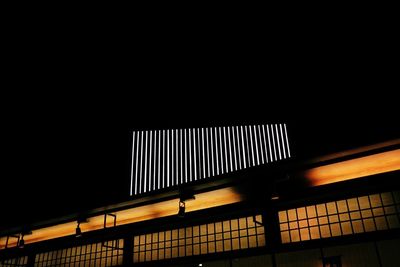 Low angle view of illuminated building against sky at night