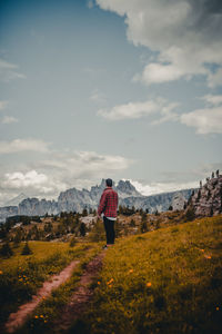 Man standing on field against sky