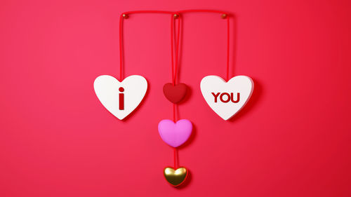 Close-up of heart shape made on pink background