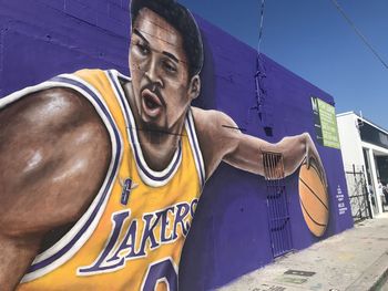 Portrait of young man against graffiti wall