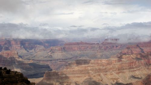 View of rock formations against cloudy sky