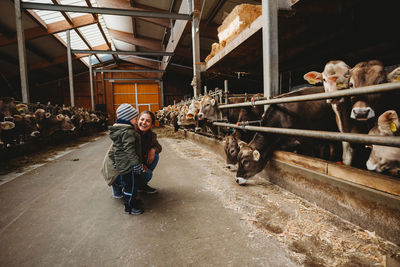 Full length of young woman in stable