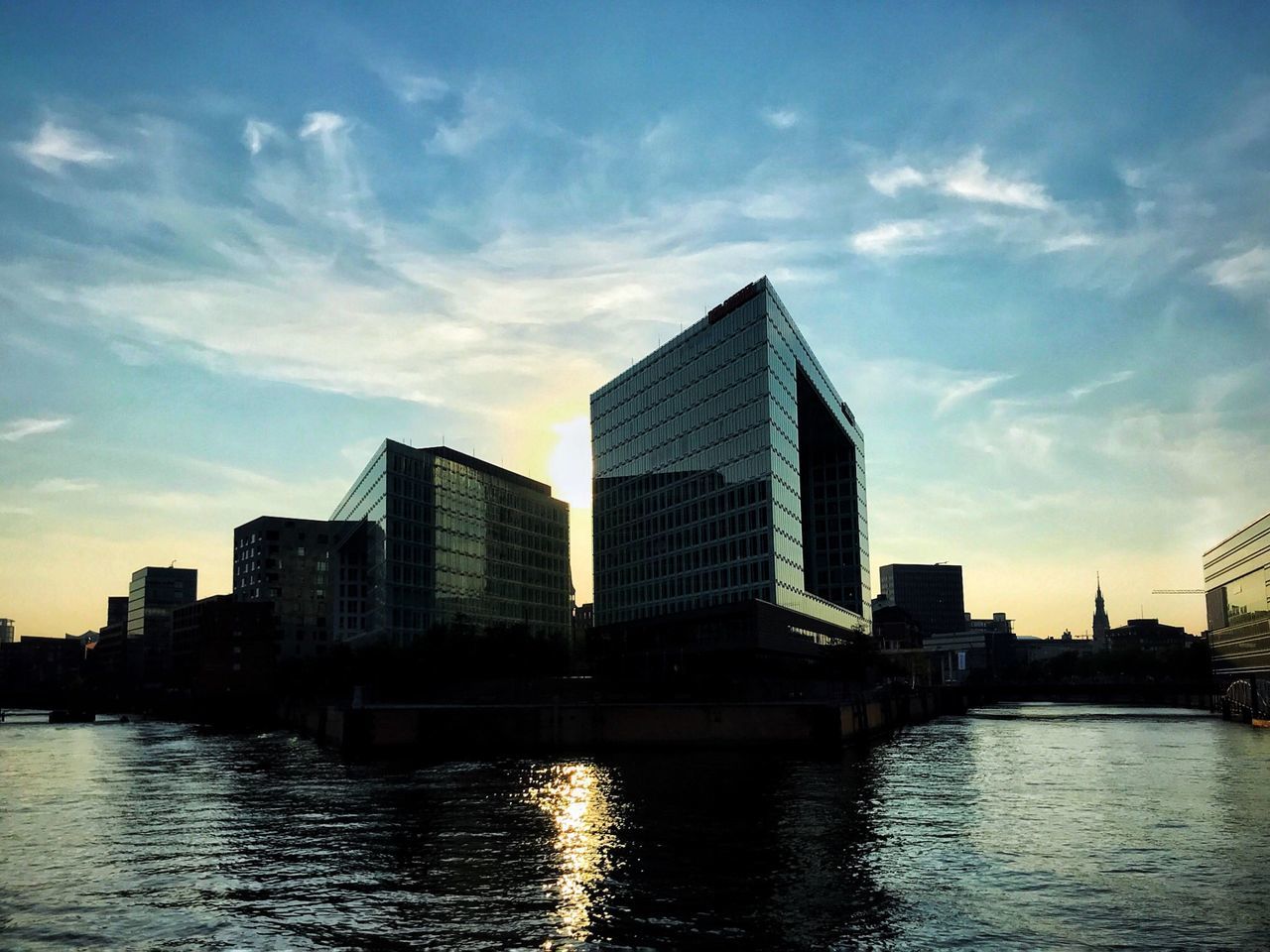 water, sky, built structure, building exterior, waterfront, architecture, city, cloud - sky, no people, building, modern, reflection, river, office building exterior, nature, sunset, outdoors, urban skyline, office, skyscraper, cityscape, financial district