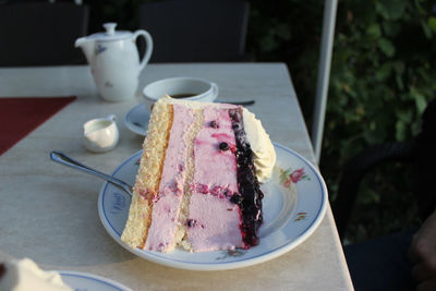 Coffee cup and cake on table