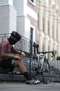 Man sitting on bicycle in city