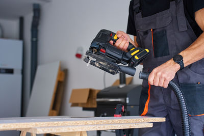 Midsection of man working in workshop