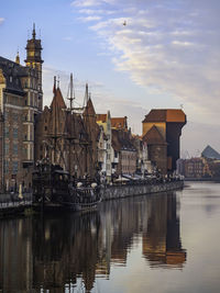 Reflection of buildings in city river in gdansk poland