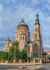 View of temple building against cloudy sky