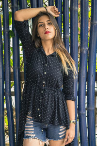 Portrait of a beautiful young woman standing outdoors