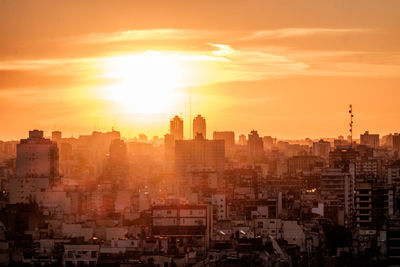 Cityscape against sky during sunset