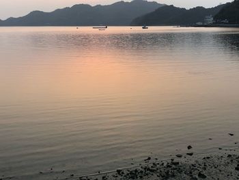 Scenic view of lake against sky at sunset