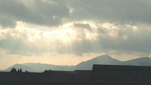 Scenic view of mountains against cloudy sky