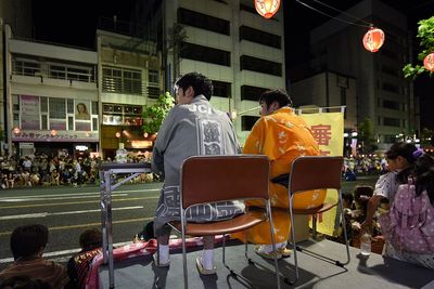 Man standing in city at night