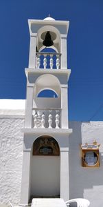 Low angle view of cross on building against sky