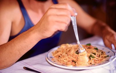 Midsection of man holding ice cream in plate