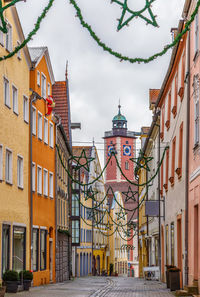 Street amidst buildings against sky