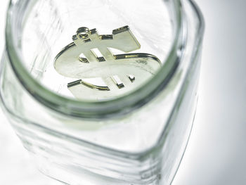 High angle view of dollar in glass jar