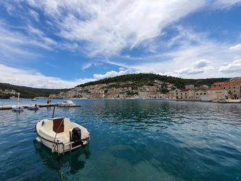 Scenic view of sea by buildings against sky