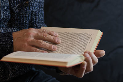 Midsection of woman reading book
