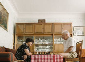 Senior couple playing chess at home