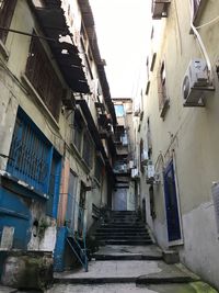 Low angle view of narrow alley amidst buildings
