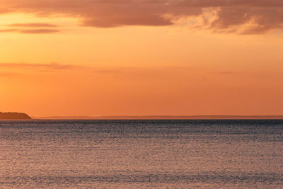 Scenic view of sea against romantic sky at sunset