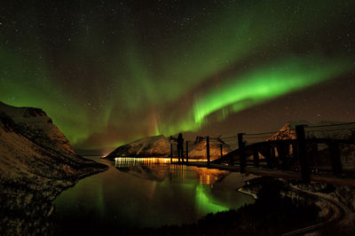 Scenic view of lake against sky at night