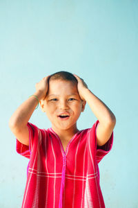 Boy against blue background