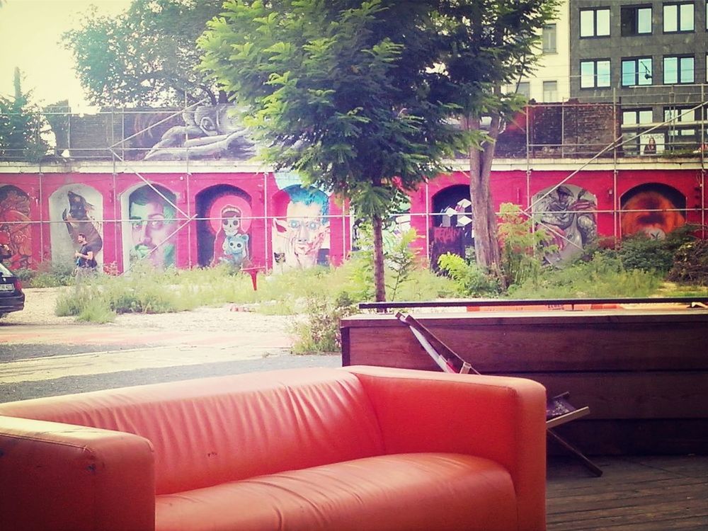 building exterior, architecture, built structure, tree, potted plant, chair, window, red, house, empty, absence, day, plant, seat, growth, wall, outdoors, no people, wall - building feature, residential structure